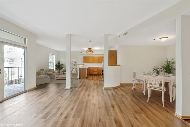 unfurnished living room featuring light wood-style flooring and baseboards