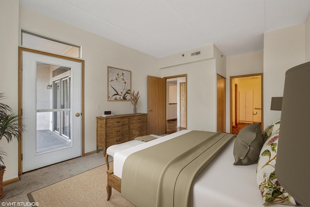 carpeted bedroom featuring visible vents