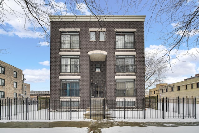 townhome / multi-family property featuring brick siding and fence