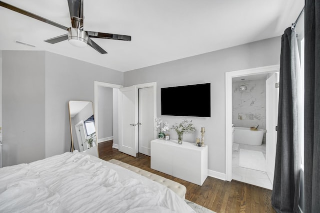 bedroom featuring ceiling fan, baseboards, wood finished floors, and ensuite bathroom