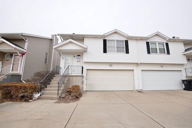 view of front of house with concrete driveway and an attached garage