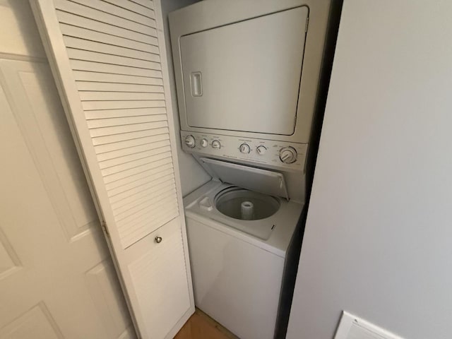 laundry room with laundry area and stacked washer / dryer