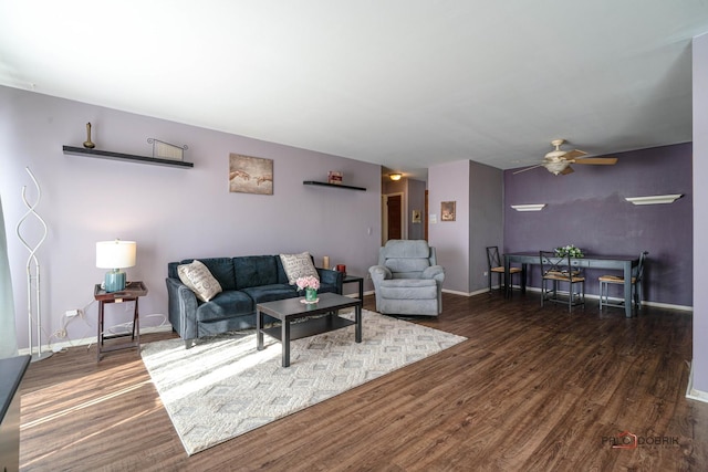 living area featuring ceiling fan, baseboards, and wood finished floors