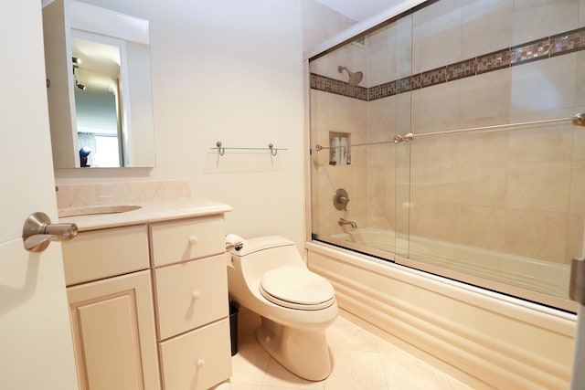 full bathroom with toilet, vanity, tile patterned flooring, and bath / shower combo with glass door