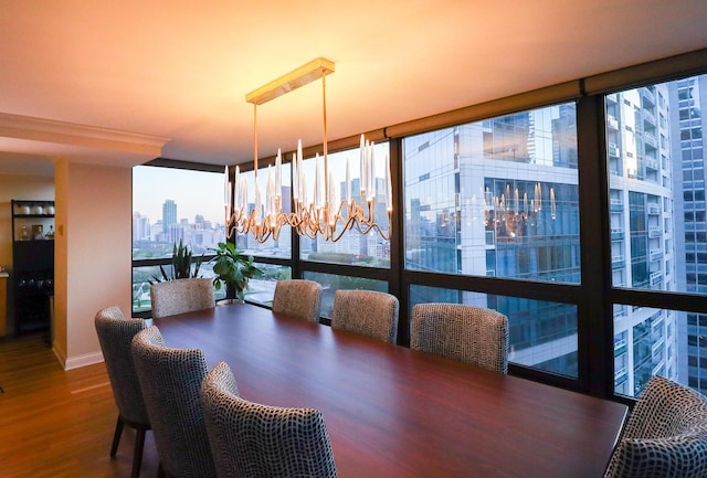 dining area featuring hardwood / wood-style floors, a healthy amount of sunlight, a chandelier, and expansive windows