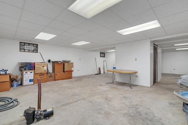 basement with a paneled ceiling