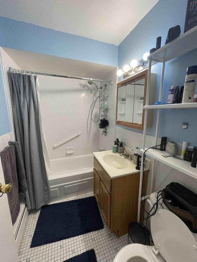 bathroom featuring shower / bath combo, vanity, toilet, and tile patterned floors