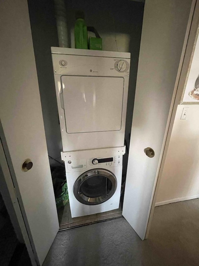 laundry room featuring laundry area and stacked washer and clothes dryer