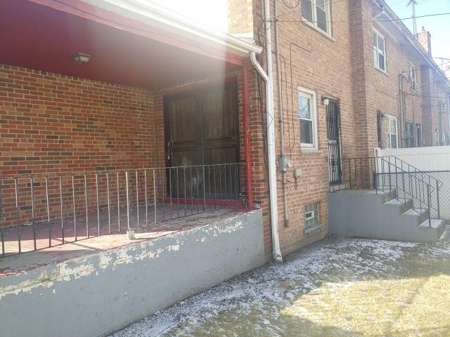 view of side of property featuring brick siding