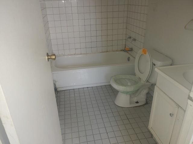 full bathroom featuring toilet, shower / bathtub combination, vanity, and tile patterned floors