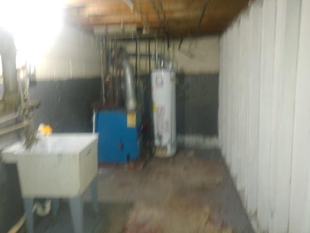 below grade area with water heater and a sink