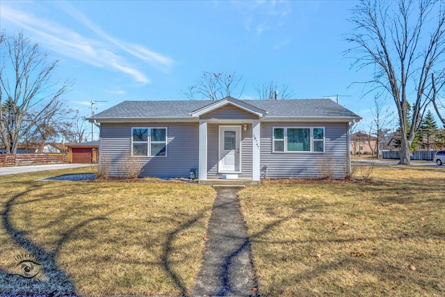 view of front of home with a front lawn and roof with shingles