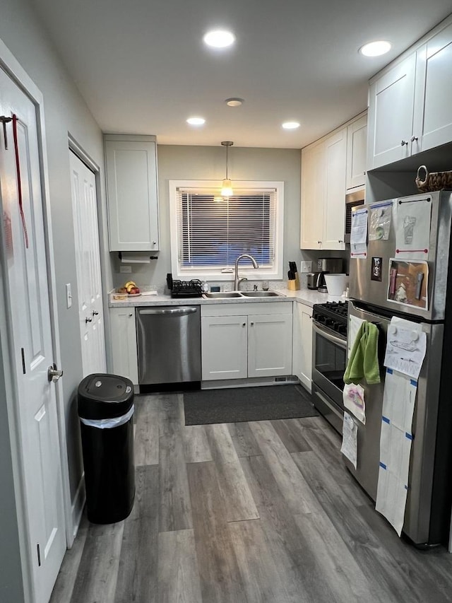 kitchen with sink, stainless steel appliances, and white cabinets