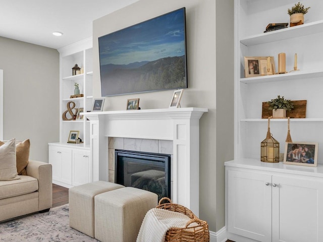 5 Fieldcrest Dr, Monticello, IL 61856 - living room with built in features, a tiled fireplace, and wood finished floors