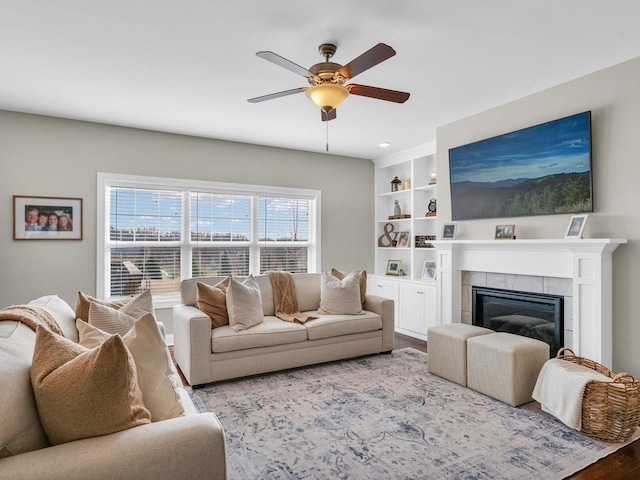 5 Fieldcrest Dr, Monticello, IL 61856 - living room with wood finished floors, ceiling fan, a tile fireplace, and built in shelves