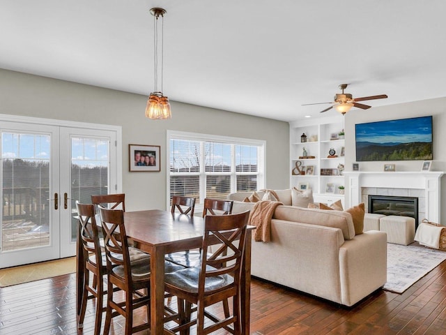 5 Fieldcrest Dr, Monticello, IL 61856 - dining space featuring plenty of natural light, dark wood-type flooring, ceiling fan, and a tiled fireplace