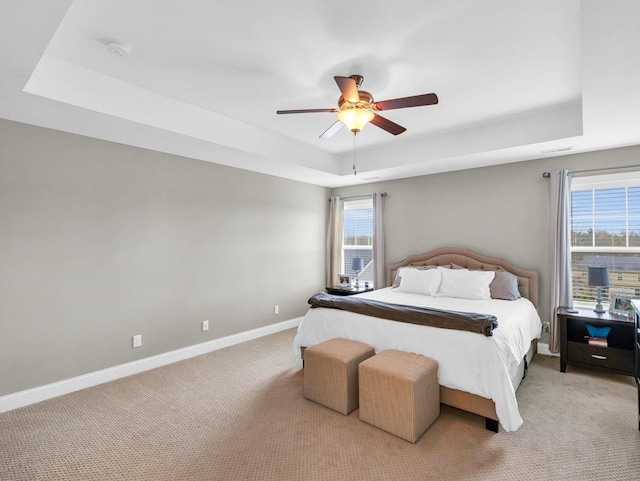 5 Fieldcrest Dr, Monticello, IL 61856 - bedroom featuring a tray ceiling, light colored carpet, baseboards, and a ceiling fan