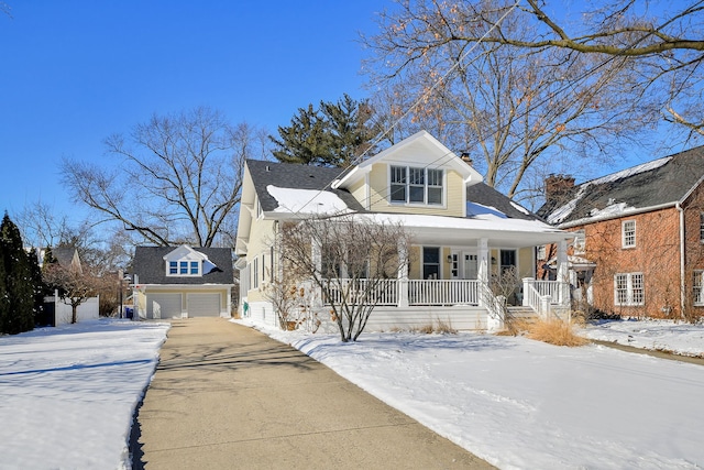 bungalow-style home with covered porch and a detached garage