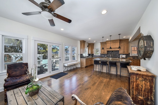 living room with a ceiling fan, french doors, dark wood-type flooring, and recessed lighting