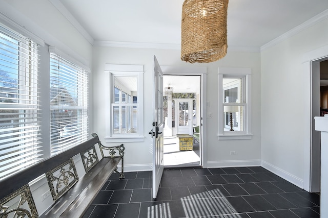 entrance foyer featuring ornamental molding, dark tile patterned floors, and baseboards