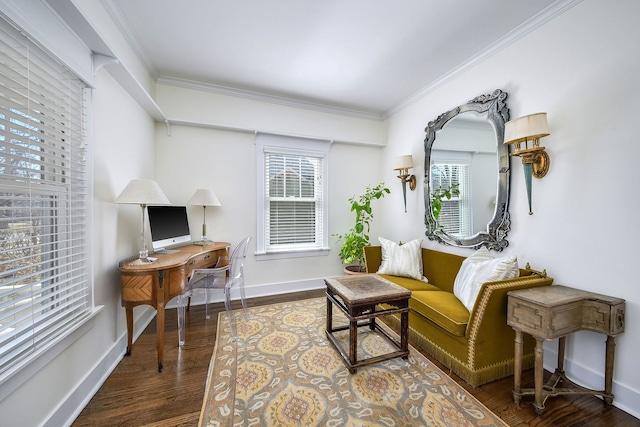 sitting room featuring baseboards, wood finished floors, and crown molding