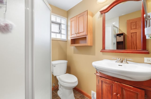 full bathroom with toilet, a stall shower, vanity, tile patterned flooring, and baseboards