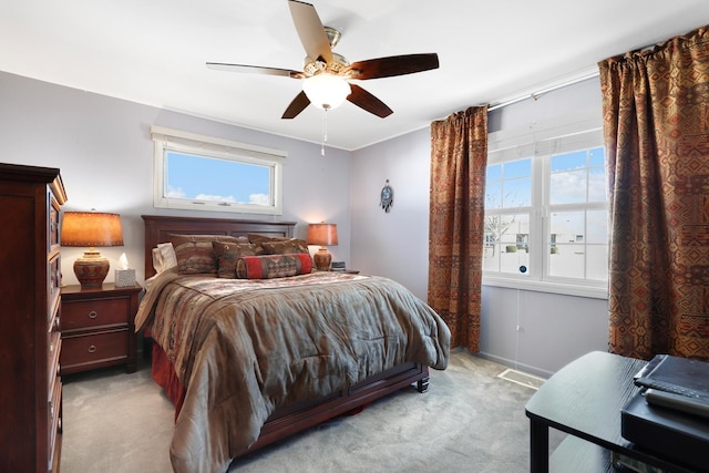 bedroom featuring light carpet and ceiling fan