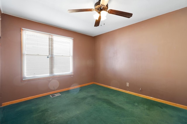 spare room with a ceiling fan, baseboards, visible vents, and carpet flooring