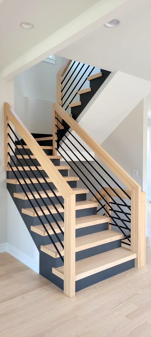 stairs with hardwood / wood-style floors