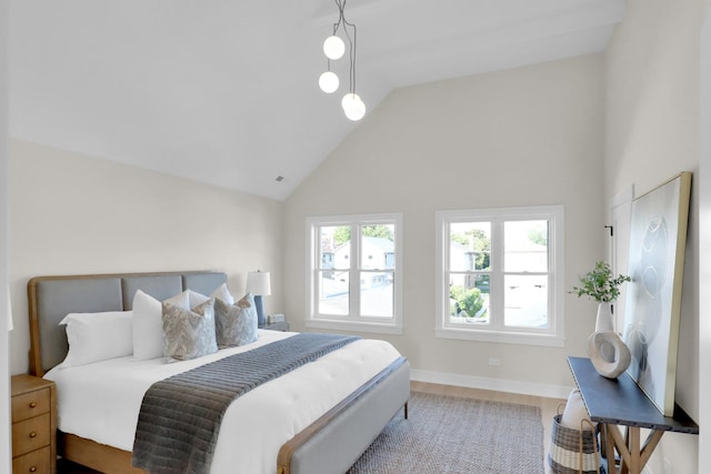 bedroom featuring high vaulted ceiling and hardwood / wood-style flooring