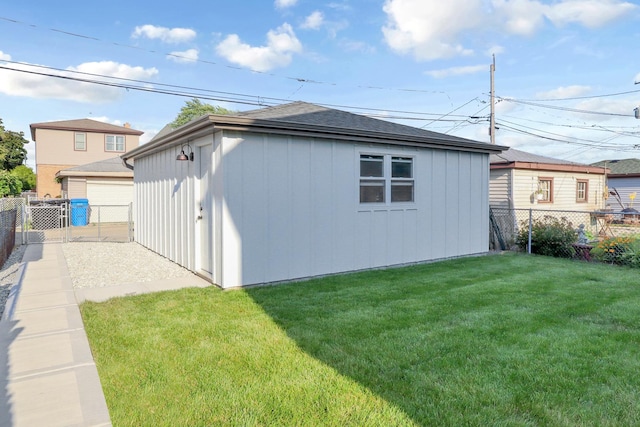 view of home's exterior with a lawn and an outdoor structure