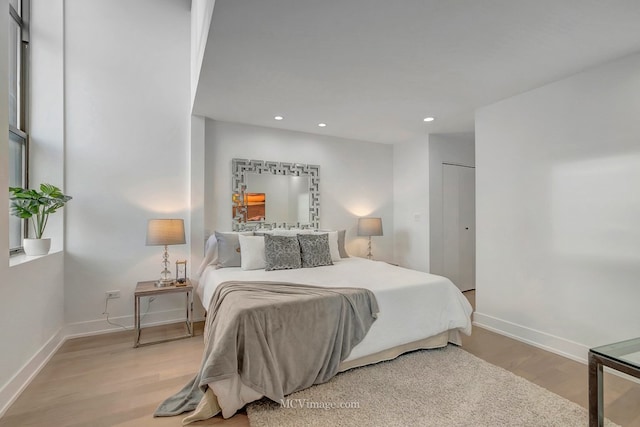 bedroom featuring recessed lighting, light wood-type flooring, and baseboards