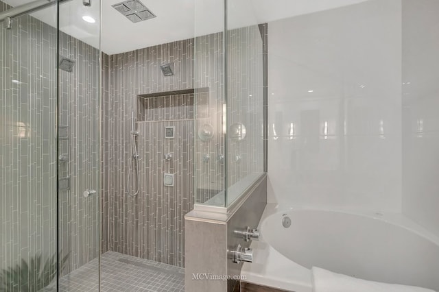 bathroom with a garden tub, visible vents, and a stall shower