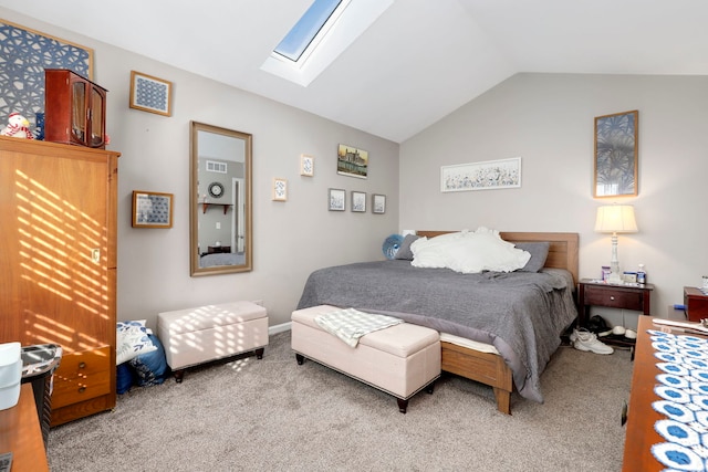 bedroom featuring light carpet, vaulted ceiling with skylight, and visible vents