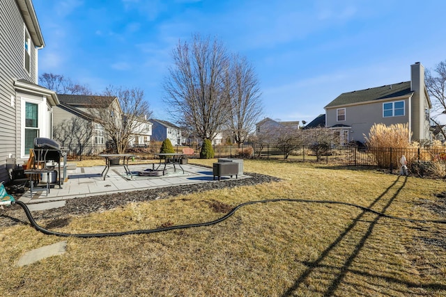 view of yard with a patio area, a fenced backyard, and a residential view