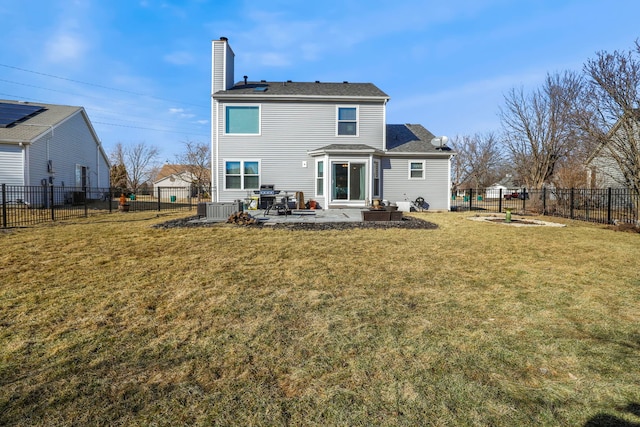 rear view of house with a patio, a fenced backyard, central air condition unit, a yard, and a chimney