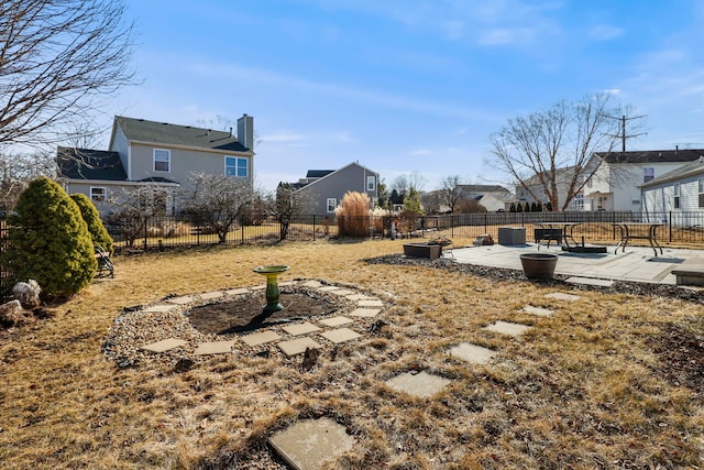 view of yard with a patio, fence, and a residential view