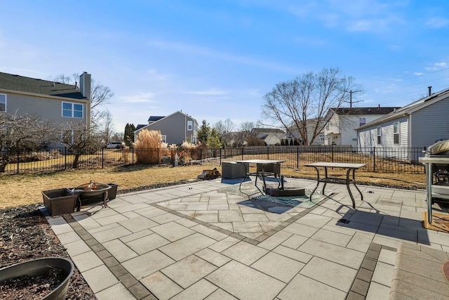 view of patio / terrace featuring a fenced backyard, a residential view, and outdoor dining area