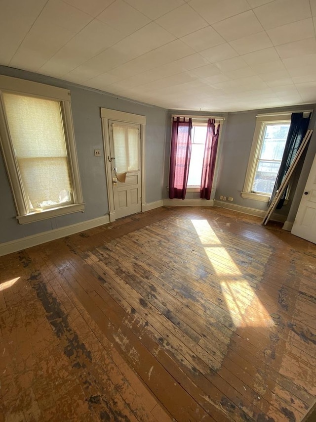 interior space with baseboards and wood finished floors