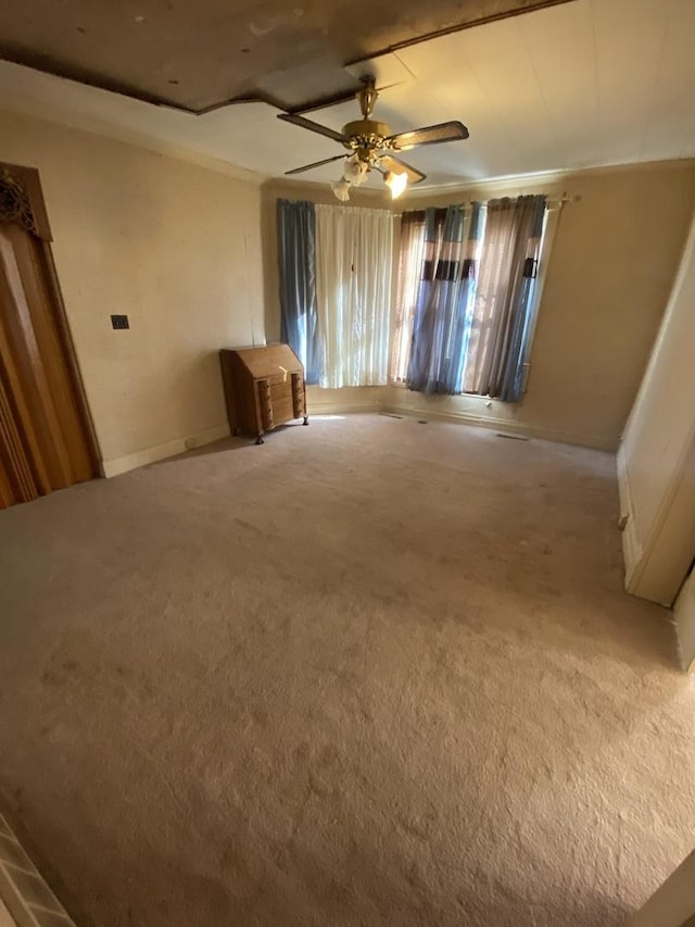 interior space featuring light carpet and ceiling fan