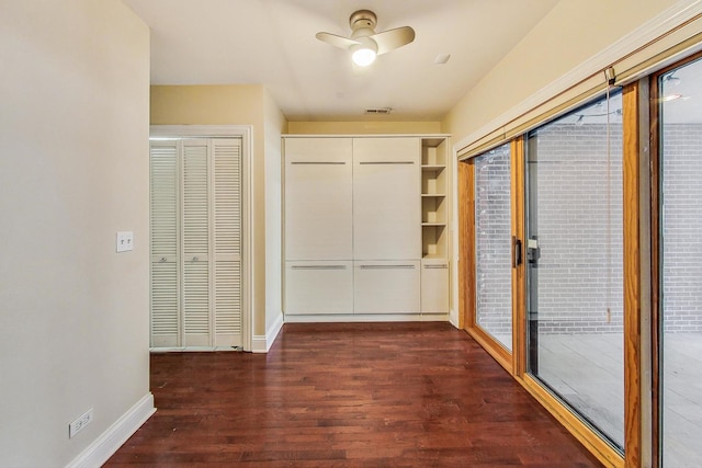 interior space with visible vents, baseboards, and dark wood-style flooring