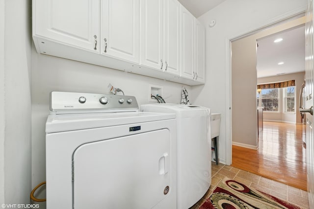 washroom with recessed lighting, baseboards, cabinet space, and washing machine and clothes dryer