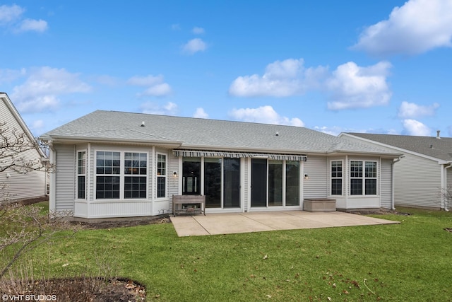 rear view of property with a patio, a shingled roof, and a lawn