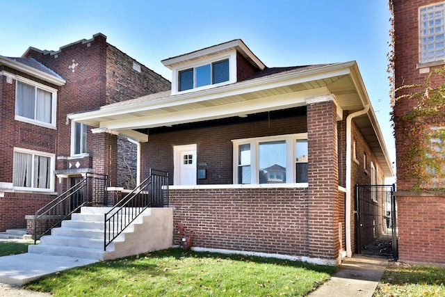 bungalow featuring brick siding and a porch