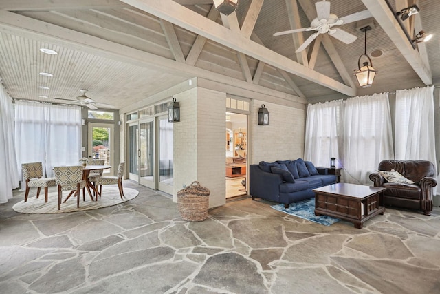 sunroom featuring lofted ceiling with beams, wood ceiling, and a ceiling fan