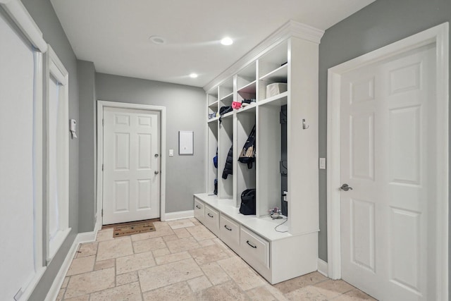 mudroom featuring recessed lighting, stone tile flooring, and baseboards