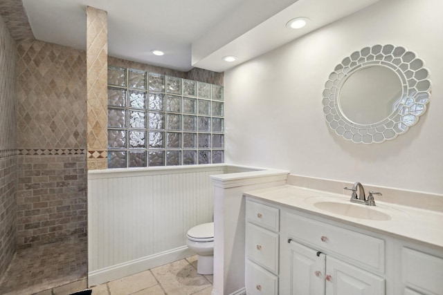 bathroom with a walk in shower, vanity, toilet, and recessed lighting