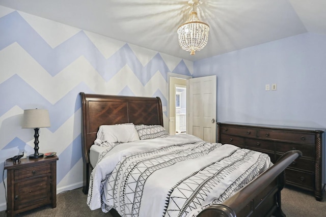 bedroom with a chandelier, dark carpet, and baseboards