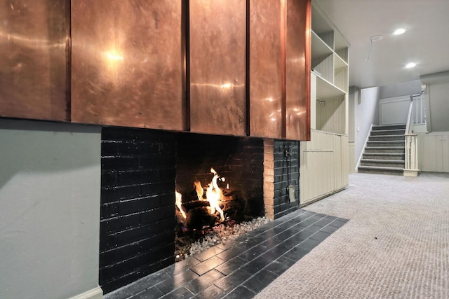 interior details featuring a fireplace, carpet flooring, and recessed lighting