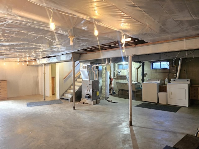 below grade area featuring stairway, water heater, heating unit, washer and dryer, and a sink